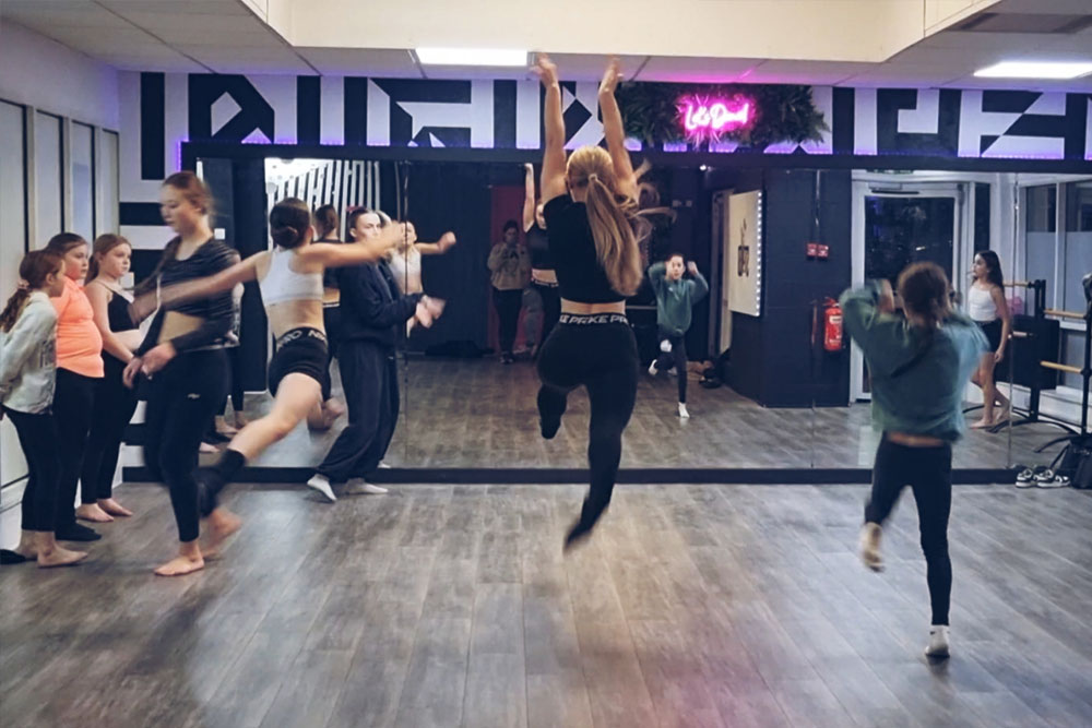 Group of kids jumping and playing in dance class